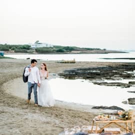 bride and groom walking at the beach