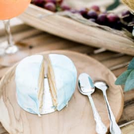 a piece of wedding cake on a wooden plate