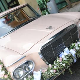Vintage white wedding car decorated with flowers, by Cyprus Motor Museum.