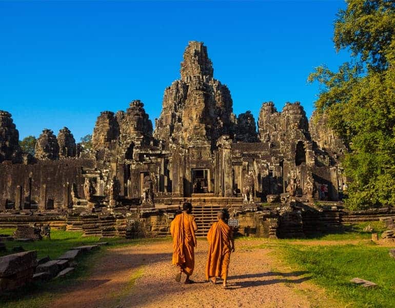 Ancient Buddhist temple ruins and two Buddhist monks, part of a honeymoon trip offered by Let's Go Tours by Amathus.