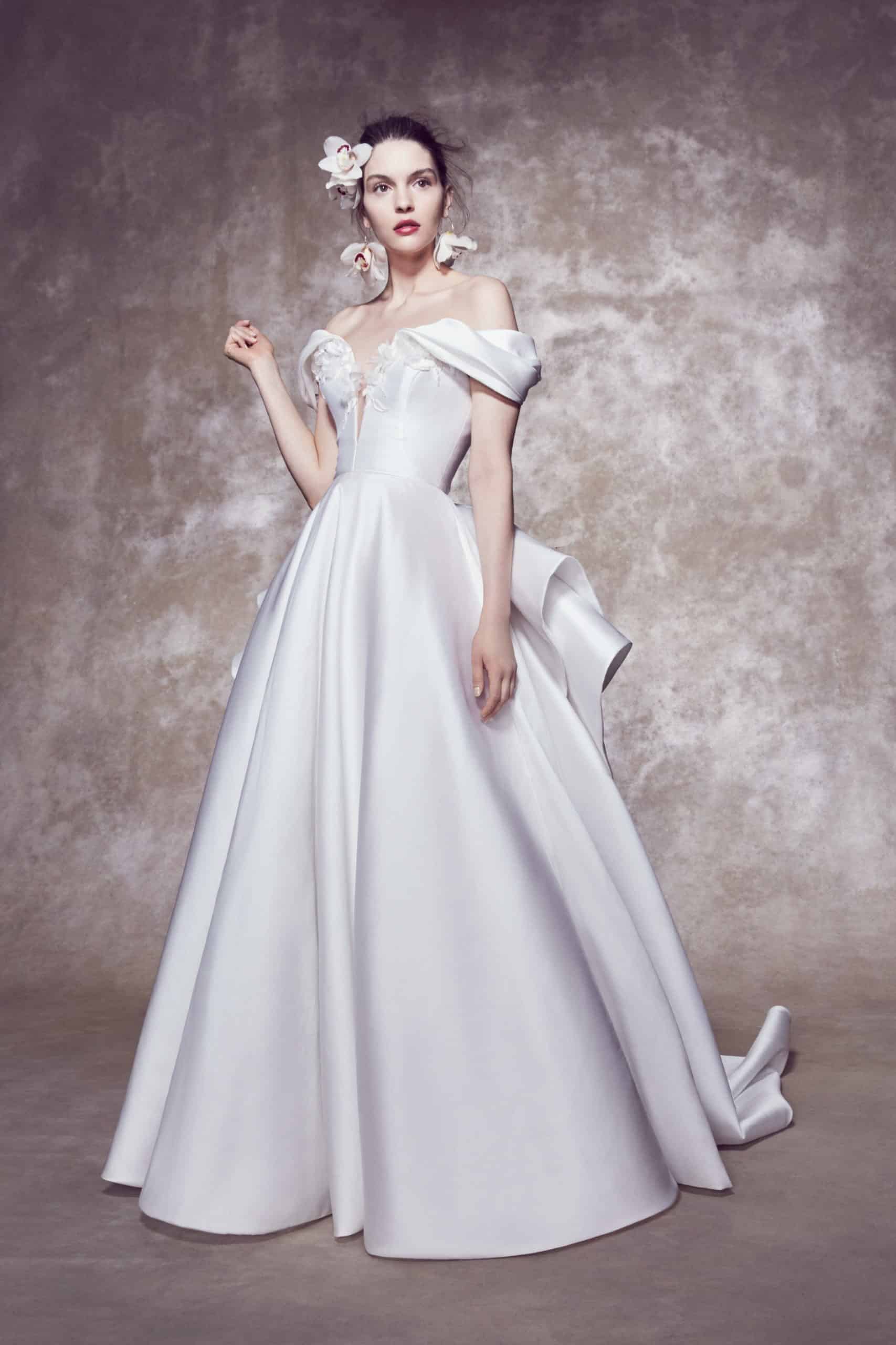 a-lined wedding dress with a back bow with a tail by Marchesa