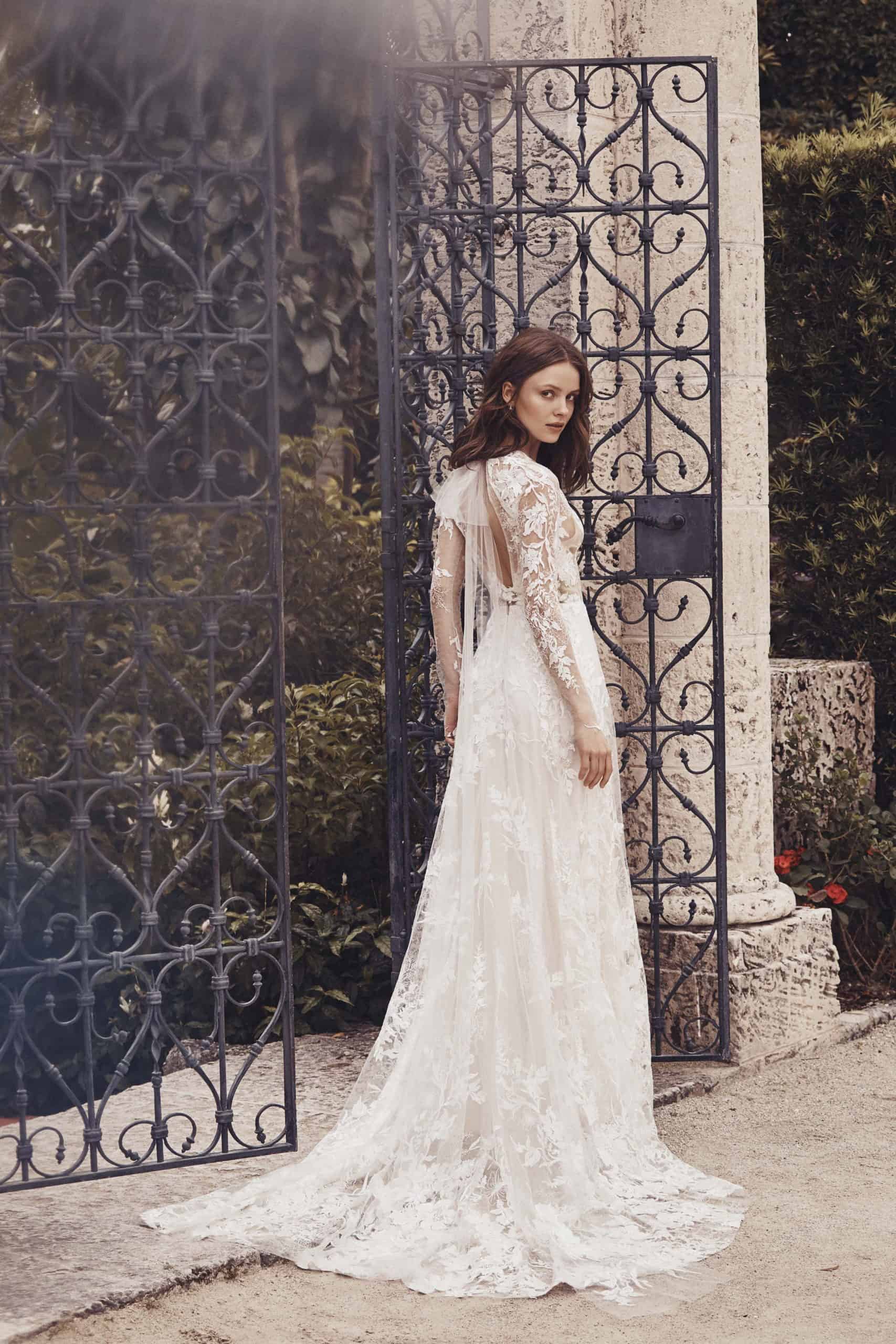 a laced wedding dress with long lace sleeves by Monique Lhuillier