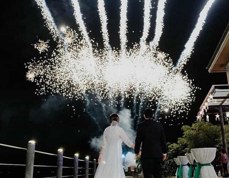White, large firework show for a wedding, newlyweds admiring, by NightLights Fireworks.