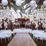 White flowers and hanging spheres decorating a wedding reception dinner, made by Paper Flowers Cyprus.