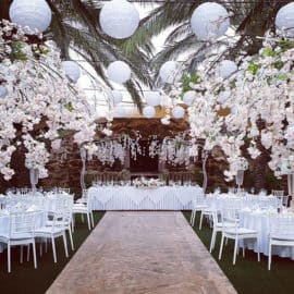 White flowers and hanging spheres decorating a wedding reception dinner, made by Paper Flowers Cyprus.