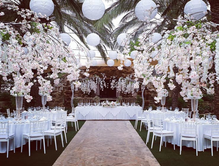 White flowers and hanging spheres decorating a wedding reception dinner, made by Paper Flowers Cyprus.