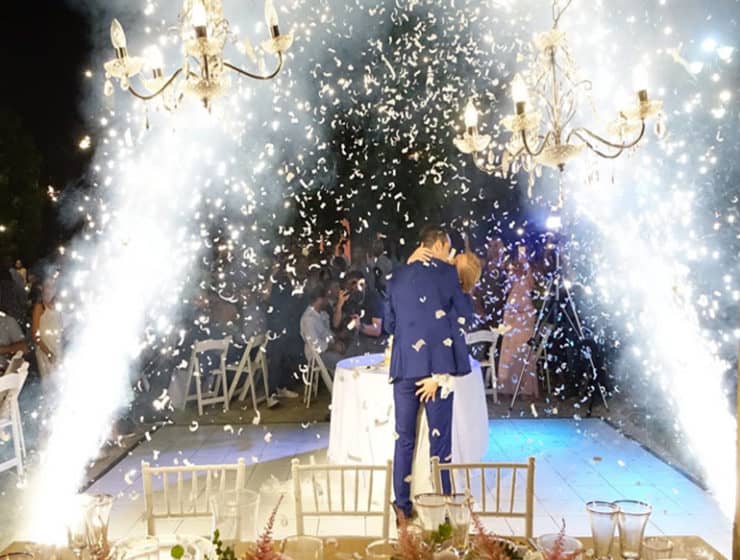 Newlywed couple kissing while celebratory fireworks and sparklers are going off, by MJD Pyrgos Fireworks and Special Effects.