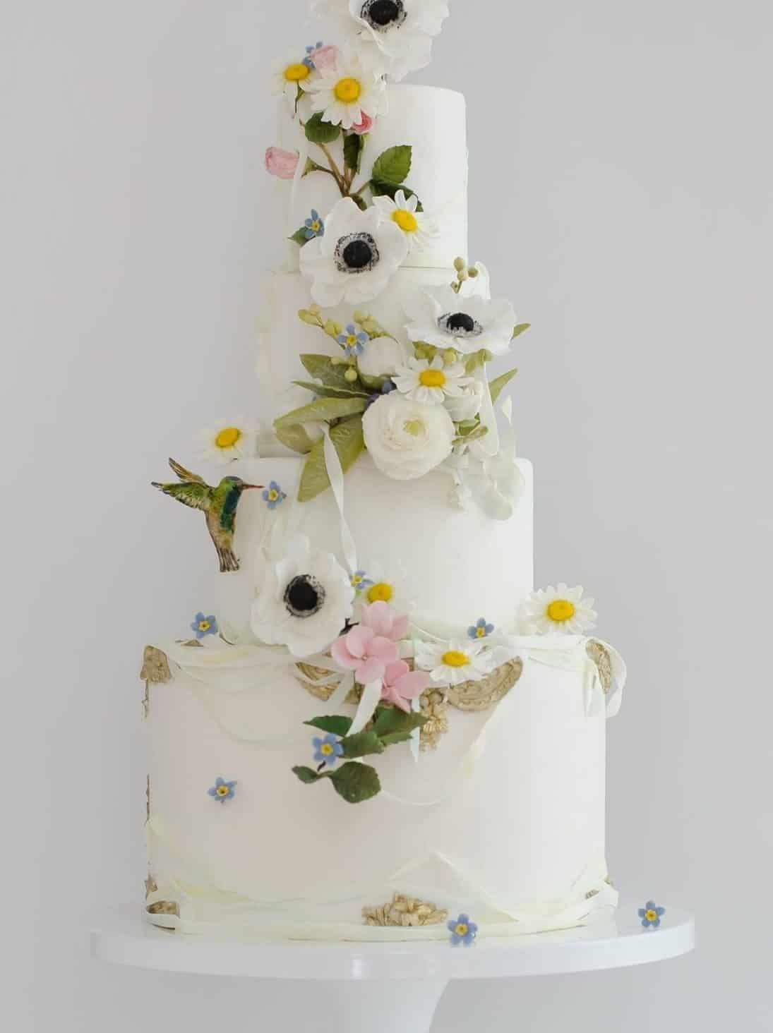wedding cake with with anemone and daisies